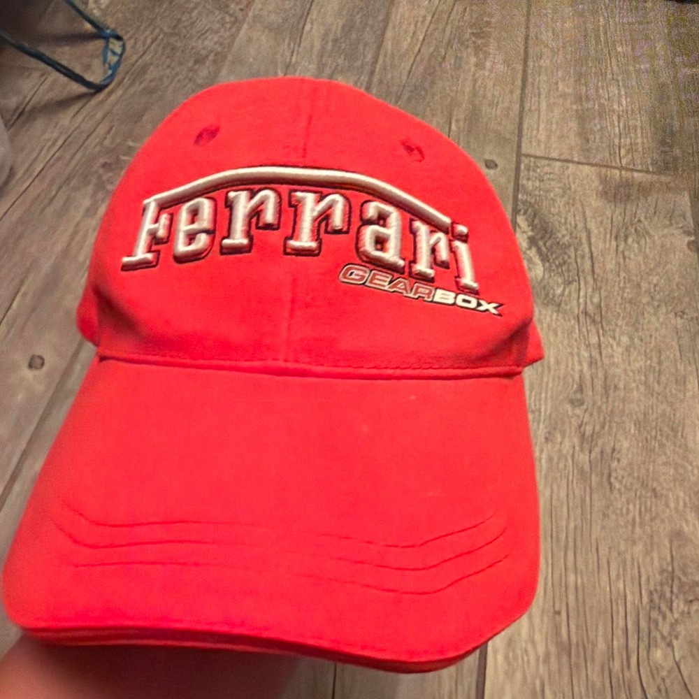 Red Ferrari cap with white 'Ferrari' text and 'GEARBOX
